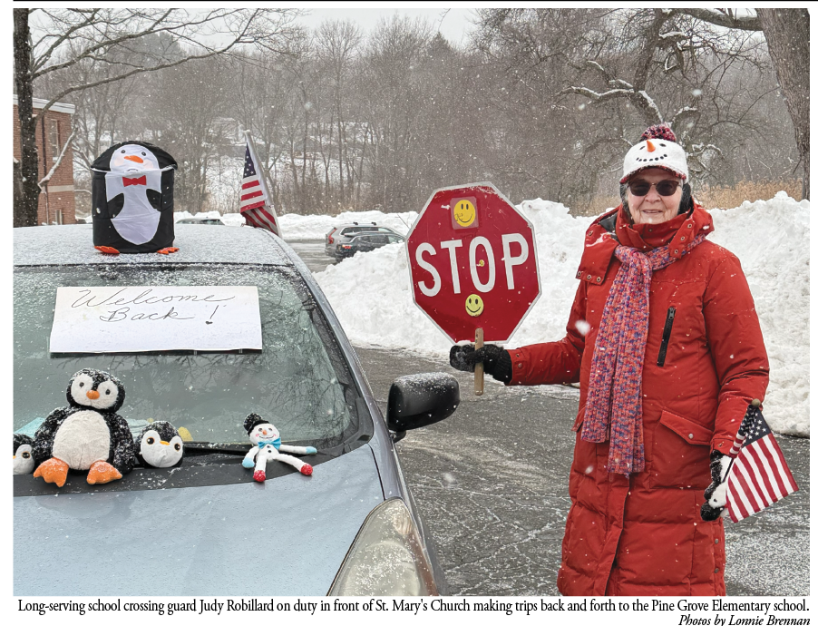 Judy Robillard welcomes students back from winter break as she performs crossing-guard duties across from the Pine Grove Elementary School in Rowley. Judy has been safely guiding and bringing cheer to students and their parents for 39 years!